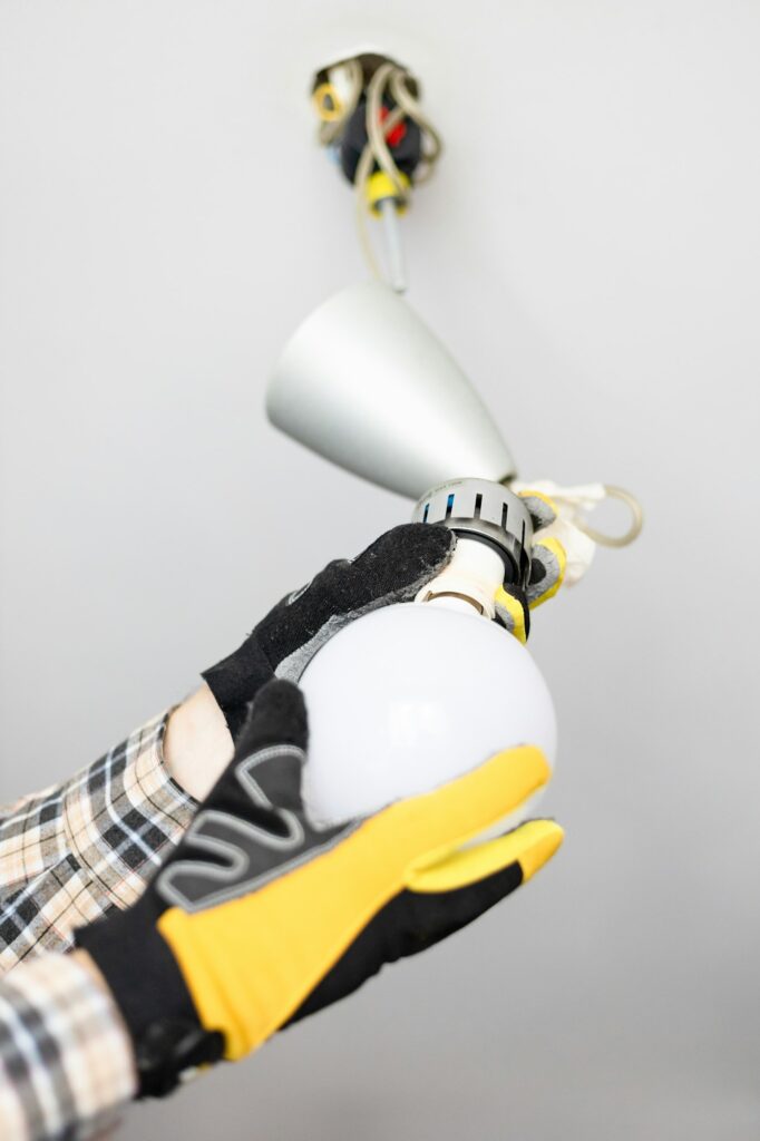 Electrician remove bulb from defective light.jpg